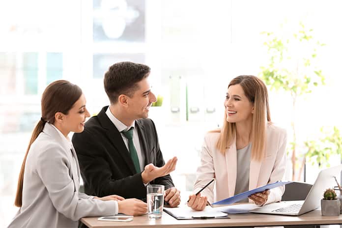 Couple signing contract with real estate agent