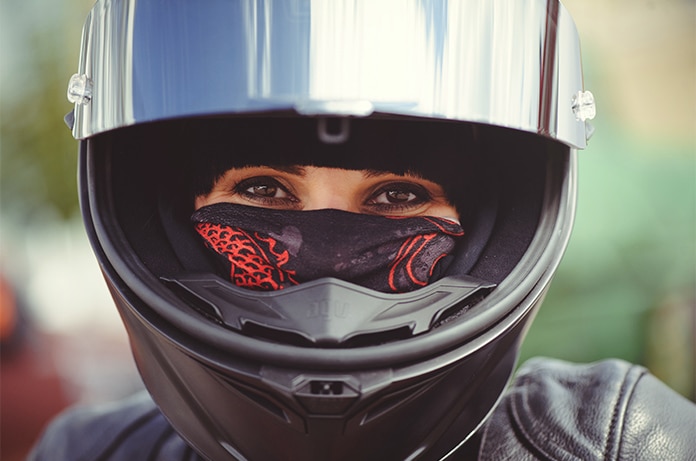Primer plano de un casco integral de motocicleta con visera reflectante, formando parte de un conjunto de equipación de protección